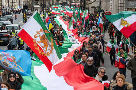 Hundreds of Iranians march in Whitehall. Members of the Iranian diaspora marched through central London from Downing Street to the Iranian Embassy carrying a 300 metre long Iranian flag in protest against the current Iranian government. Demonstrators called for regime change and voiced support for Shah Reza Pahlavi, chanting slogans and waving royal symbols as the procession moved through the capital.
