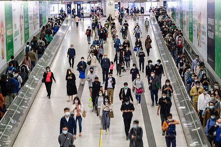 Commuters wearing face masks as a preventive measure against the spread of Covid-19 coronavirus walk through the Central MTR station.
Hong Kong has reported a spike of new coronavirus (Covid-19) infections, with the majority of them linked to the cluster originating at a gym in Sai Ying Pun district.