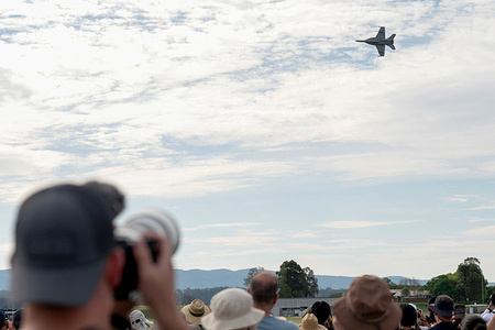 A general view as members of the public watch a Boeing F/A-18F Super Hornet performing during the Royal Australian Air Force (RAAF) Richmond Airshow 2025 at the RAAF Airbase in Richmond. The RAAF Richmond Airshow on 27 and 28 September 2025 commemorate 100 years of RAAF Base Richmond. The airshow showcases Australian Defence Force aircraft, military capabilities and Defence personnel.