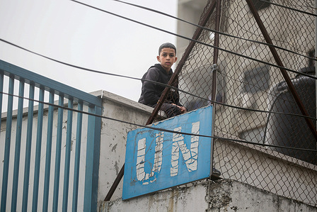 A Palestinian student sits on the roof of a UNRWA school during the demonstration in Balata refugee camp, east of Nablus in the West Bank, protesting UNRWA's reduction of education and health services and the cutting of salaries of its employees in refugee camps in the West Bank.