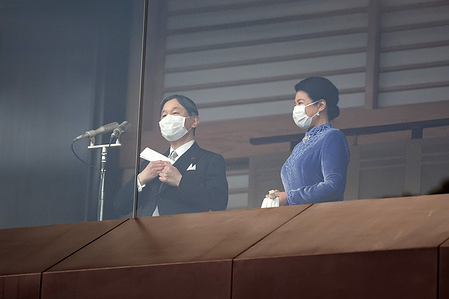 Japan's Emperor Naruhito (L) and Empress Masako greet the public on his birthday.