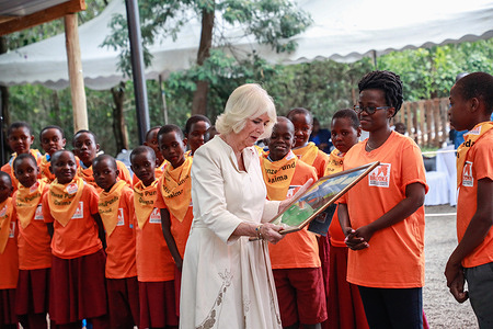 Queen Camilla admires a donkey portrait given to her by children from the Action for Working Horses and Donkeys during a visit to the Brooke Donkey Sanctuary in Nairobi. Queen Camilla and King Charles III are in Kenya for a state visit under the invitation of president William Ruto.