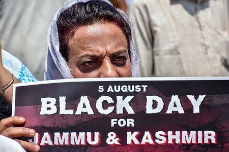 A supporter of Indian National Congress (INC) holds a placard during a protest against the abrogation of Article 370 and Article 35A which provided a special status to Jammu and Kashmir and against the downgrading of Jammu and Kashmir from a state to a Union territory. The government of Prime Minister Narendra Modi abrogated article 370 on August 5th, 2019.