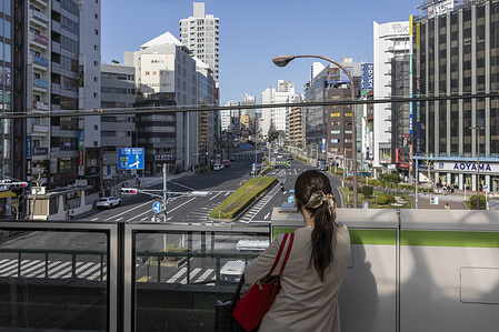 Woman waits for a Yamanote line subway train at Gotanda station in Tokyo. Hanami season at Meguro River (Nakameguro, Tokyo) is one of the city's most iconic and photogenic cherry blossom experiences. Roughly 800 cherry trees (mostly Yoshino sakura) line both banks of the Meguro River for several kilometers, forming a stunning pink tunnel or canopy over the water, especially beautiful around late March to early April (typically peaking in the last week of March). Meguro River stands out as a prime hanami destination because it offers a perfect mix of nature and urban scenery in a relatively compact, accessible spot (just minutes from Shibuya or via Nakameguro/Meguro stations).