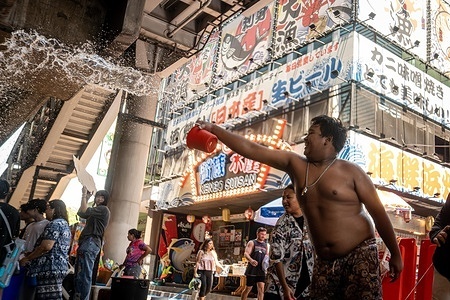 A boy throws water along a street near Silom during the Songkran celebrations. The kickoff of Songkran on Silom Road marks the start of Thailand’s New Year with one of Bangkok’s most iconic celebrations. Traditionally rooted in rituals of cleansing and renewal, the festival has evolved into a vibrant public event where crowds gather for large-scale water fights. Silom, with its central location and lively atmosphere, has become a key hotspot, drawing both locals and visitors into the heart of the festivities.
