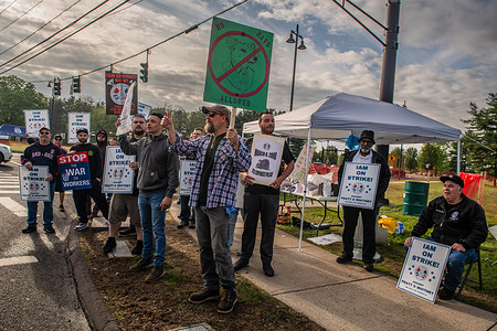 Machinist union workers' hold placards during a strike against Pratt & Whitney. Mass strike at Pratt & Whitney after contract talks regarding wages, job security and benefits fail. Thousands of machinist union workers strike against Pratt & Whitney.
