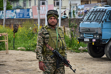 A paramilitary trooper stands alert in Srinagar, the summer capital of Jammu and Kashmir. India bans the import of goods coming from or transiting via Pakistan and bars Pakistani ships as tensions rise between the nuclear-armed neighbors following a deadly attack on tourists in Kashmir.
