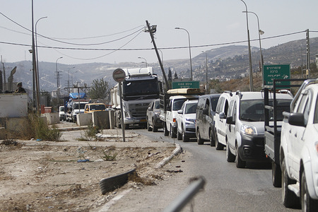 Many cars seen waiting in front of the Hawara checkpoint during its closure by the Jewish settlers as they pray near the city of Nablus in the occupied West Bank.