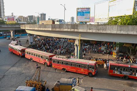 MUMBAI, INDIA - MAY 24, 2020: Crowd of migrants boarding the buses at a station.
People mostly migrants have to wait for the free government provided buses to travel back to their hometown from Mumbai. The buses drop the migrants at the border of their states, where they have to find their own means.
