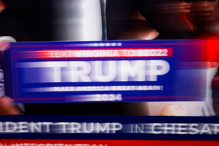 This monitor photo shows a campaign podium and the political slogan popularized by former US President Donald Trump during his 2016 presidential campaign: "Make America Great Again" during a speech in Chesapeake, Virginia. Former President Donald Trump criticized President Joe Biden's debate performance before the election, calling him incompetent and raising concerns among Democrats. Trump addressed supporters at a rally in Virginia, saying Biden was stumbling and unable to finish sentences, prompting discussions about replacing him before the election. Trump emphasized the importance of choosing not just a tough candidate, but a capable leader for America.