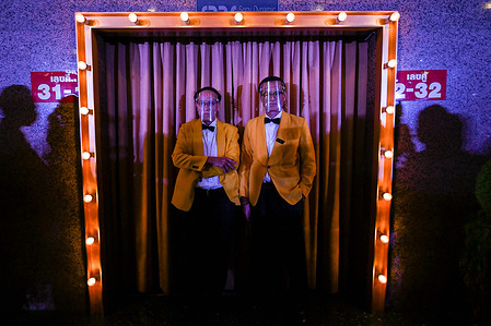 Cinema ushers wearing face shields stand outside the entrance to the Scala theater on July 3, 2020 in Bangkok.
The Scala theater has shut its doors after 51 years as a shrine for Thai movie-goers.