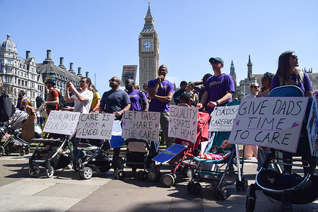 Fathers gather with prams and placards in Parliament Square during a demonstration demanding improvements in paternity leave. Paternity leave in the UK is described as 'the worst in Europe' with only two weeks and 194 pounds per week.