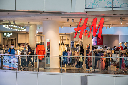 Shoppers are seen at the Swedish multinational clothing design retail company Hennes & Mauritz, H&M store in Hong Kong.
