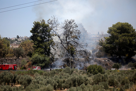 Israeli fire trucks extinguish fires near the Israeli settlement of Havat Gilad, adjacent to the West Bank city of Qalqilya. Several fires had broken out in the northern West Bank, forcing the evacuation of Havat Gilad and injuring at least two firefighters, according to police and rescue teams.