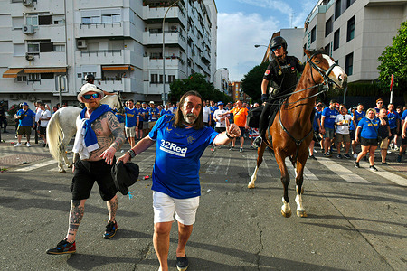 A mounted police officer rides past the Glasgow Rangers fans outside the Ramón Sánchez-Pizjuán Stadium. Prior to the Europa League final match between Eintracht Frankfurt and Glasgow Rangers at the Ramón Sánchez Pizjuán Stadium in Seville, the fans of both teams filled streets of the Spanish city with chants and cheers to support their teams. Under intense police control, the Spanish authorities sought to reduce any acts of violence or vandalism by fans of both teams.