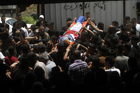 (EDITORS NOTE: Image depicts death)
Mourners carry the body of one of the two Palestinians who were killed when a homemade explosive device exploded while it was being planted in a street in Balata refugee camp near Nablus in the occupied West Bank Palestinians use homemade explosive devices against Israeli military vehicles as they storm the Palestinian areas as a kind to protest against these incursions of Israeli forces, but resulted in many Palestinian deaths.