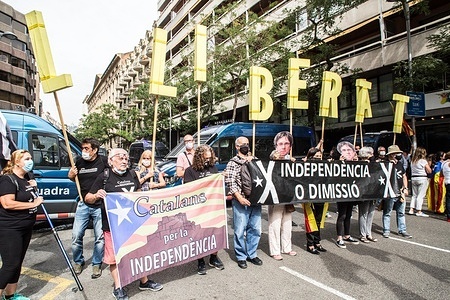 Protesters hold banners and signs during the demonstration.
Catalan independence groups demonstrate outside Italian consulate in Barcelona after the arrest of exiled former Catalan president Carles Puigdemont in Italy.