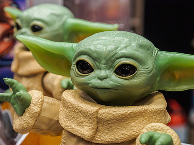 A figurine of the main character of the popular TV series "Mandalorian" Grogu (baby Yoda) seen in a store.
