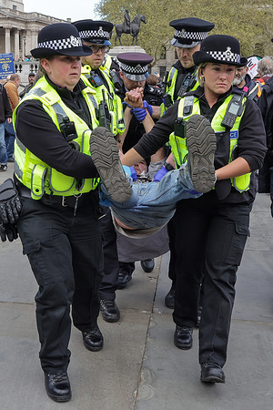 Police officers detain a supporter of Palestine Action for holding a placard during a mass ‘Everyone Day’ protest in Trafalgar Square. The demonstration organized by Defend Our Juries as part of its campaign to end the proscription of the group, opposing what organizers describe as the Home Secretary’s unlawful ban. In March, the Metropolitan Police said officers would resume arresting suspected supporters as a High Court case over the ban continues.