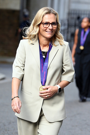 England women football team manager Sarina Wiegman arrives with her medal for a reception at 10 Downing Street.