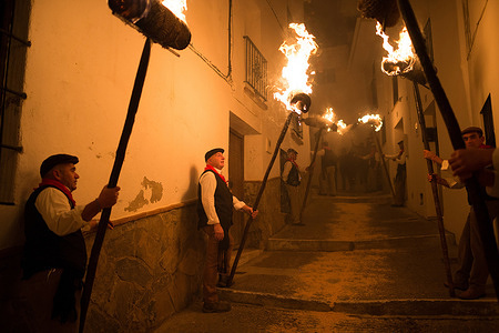 Villagers are seen holding torches on the street during the celebration of the 'Divina Pastora' Virgin procession.
On the eve of the feast of St. Lucia in the small village of Casarabonela, every night of 12 December during Christmas season villagers take part in the ancient celebration of 'Los Rondeles' carrying burning wickers baskets (also known as 'rondeles') soaked in oil. Along the streets, the Virgin of 'Los Rondeles' is honoured by the devotees in a ritual of light and fire as thanksgiving for the harvest obtained.