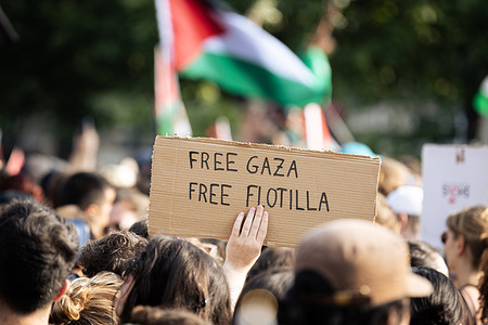 A protestor holds a placard that says "Free Gaza Free Flotilla" during a demonstration. Thousands of people gathered in Place de République, in Paris, to support the Palestinians and call for the ‘release’ of the crew of the Madleen, the humanitarian ship boarded by Israel off the coast of Gaza on Sunday night.