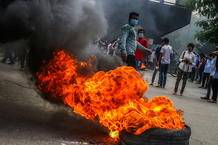 Student activists block a road and burn tyres in the road during a protest.Student protesters blocked Shahbagh intersection in Dhaka this afternoon, demanding the realization of their nine-point demand and protesting against recent alleged rape and torture of a woman in Dhaka.
