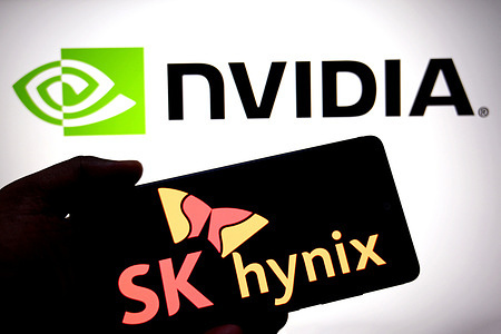 In this photo illustration, a SK hynix logo is seen displayed on a smartphone with a Nvidia logo in the background.