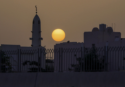 Sunset next to a mosque minaret appears in the sky on the fourth day of Dhu al-Hijjah, the last month of the Islamic calendar, named after the Hajj pilgrimage, the fifth pillar of Islam.