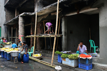 Vendors seen selling next to shops on the ground floor of Wahed Mansion, ground zero of the Chawkbazar inferno, being worked on for reopening even though the building itself is at risk during the aftermath of a massive fire that was sparked from a huge chemical factory, the fire left 70 dead and many injured.