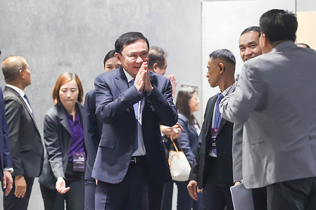 Thailand's former Prime Minister Thaksin Shinawatra greets participants at a seminar hosted by the Mass Communication Organization of Thailand (MCOT) at Queen Sirikit National Convention Center (QSNCC).