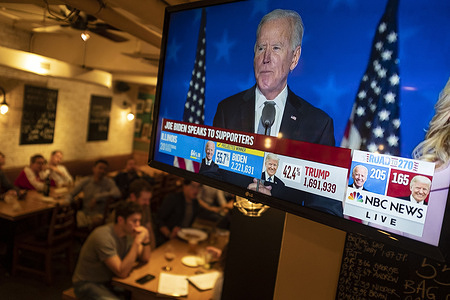 Joe Biden speaks to supporters during the US Presidential election show on a live screen at a bar.
U.S. President Donald Trump falsely declared early Wednesday he had won re-election against Joe Biden and said he would ask the Supreme Court to intervene, even as several battleground states continue to count votes.