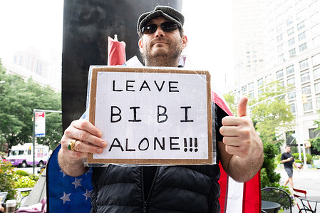 A counter-protester holds a placard saying "Leave Bibi alone!!!" during a rally for a deal to free hostages held in Gaza and against Israeli Prime Minister Benjamin Netanyahu, at Dante Park in New York City.