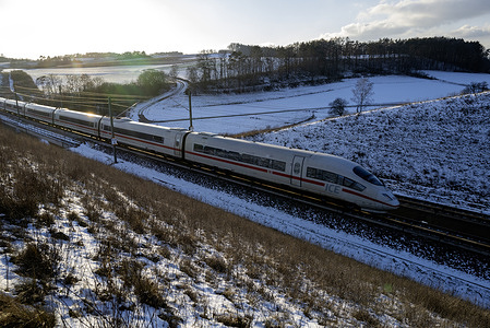 A Deutsche Bahn train crosses a winter landscape. A Deutsche Bahn train travels this evening on the day the public learned that only 60 percent of Bahn trains arrive on time. Deutsche Bahn is struggling to please its customers at the moment and these figures will not help restore much needed confidence.