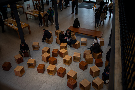 Several people check phone numbers at a phone shop in Madrid. Pedro Sánchez, the Prime Minister of Spain, announced that Spain will prohibit access to digital platforms for minors under the age of sixteen at the annual World Governments Summit, held in Dubai, United Arab Emirates.