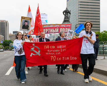 Russians march with a Soviet victory banner during the Immortal Regiment (Bessmertny polk) march to mark the upcoming Victory Day. The Immortal Regiment (Bessmertny polk) is a massive civil event in major cities around the world every May 9 during the Victory Day celebrations. It involves people carrying on the memory of war veterans with participants carrying pictures of relatives or family friends who served in the country's labor sector, paramilitary units, the Soviet Armed Forces and law enforcement organizations during the Second World War.