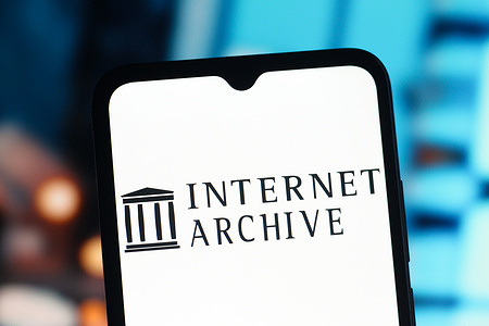 In this photo illustration, the Internet Archive logo is seen displayed on a smartphone screen.