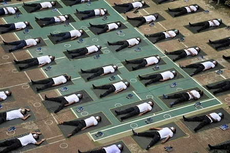 Members of the Bangladesh police wearing face masks attend a yoga session to boost their immune system during the COVID-19 coronavirus pandemic in Dhaka.
Dhaka Metropolitan Police’s (DMP) Diplomatic Security Division has started the yoga sessions devised for over 1,000 cops of the division.