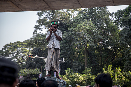 A rickshaw driver prays on top of his rickshaw outside the International Crimes Tribunal after ousted Bangladeshi prime minister Sheikh Hasina was found guilty of crimes against humanity and given a death sentence. Former Prime Minister Sheikh Hasina fled in August 2024 after many people were killed amidst a crackdown on mass protests against her government.