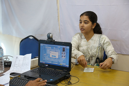 A youth scans her biometric data to register her name on the voter list during the preparation for Nepal's House of Representatives election scheduled for March 5, 2026 at the District Election office. Eligible voters are lining up enthusiastically to register their names to be able to vote in the upcoming elections.