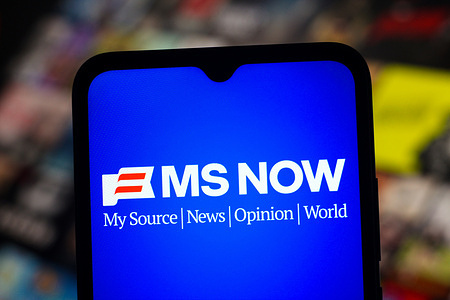 In this photo illustration, the MS NOW - My Source News Opinion World (MSNBC) logo is seen displayed on a smartphone screen.