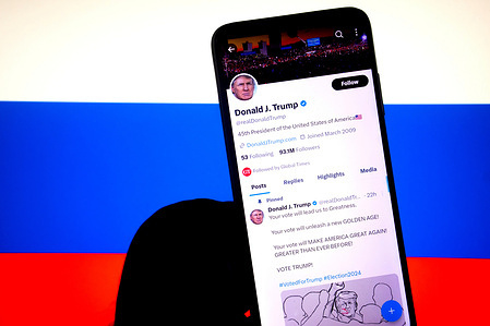 In this photo illustration, Donald J Trump's X Page is seen displayed on a smartphone with a Flag of Russia in the background.