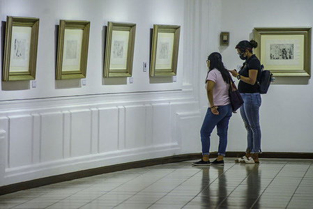 Women observe a painting from Spanish artist, Pablo Picasso at an exhibition displaying the late painter´s artwork featured from The Burial of the Count of Orgaz, and Double Flute. Art exhibits are amongst the activities opened to the public as the COVID-19 pandemic continues to hit El Salvador.