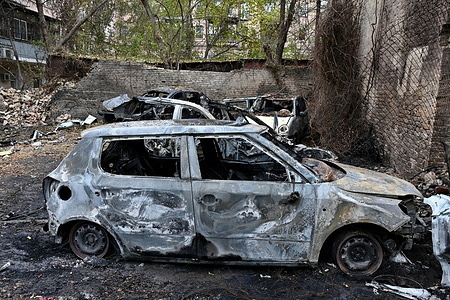 Burnt cars near an apartment building damaged in a nighttime Russian drone strike amid Russia's attack on Ukraine, in Kyiv, Ukraine.
