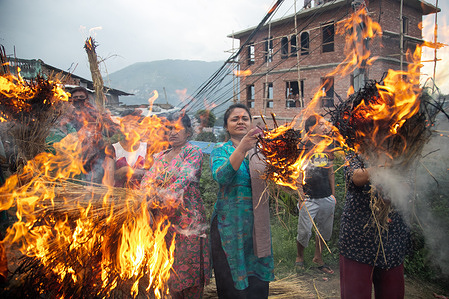 Nepali devotees carry traditional torches on the way to Bungmati temple, as they welcome the idol of Rato Machhindranath during the last day of the festival.
Devotees took down the red god from its chariot in Pulchok and carried it to its temple in Bungamati. The annual chariot festival Rato Machhindranath skipped out on its traditional route and series of high-profile cultural events like Bhoto Jatra in Jawlakhel and coconut throwing in Lagankhel due to the Covid-19 pandemic.