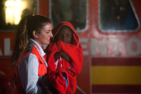 A member of Spanish Red Cross is seen carrying a migrant child after his arrival at the Port of Malaga. Spain's Maritime Rescue service rescued 60 migrants aboard a dinghy crossing the Alboran Sea and brought them to Malaga harbour, where they were assisted by the Spanish Red Cross. A total of 280 migrants were rescued this week from various dinghies trying to arrive toward the Spanish coasts, about 137 migrants this Sunday and others 143 during the Saturday.