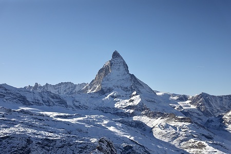 The Matterhorn mountain (middle) and other peaks in the Swiss Alps are seen from the Gornergrat viewpoint in Zermatt. Gornergrat is accessible by a cogwheel mountain train, which is one of the highest railways in Europe. The famous shape of the Matterhorn has long been used on the packaging of Toblerone Swiss chocolates, Wallis,
