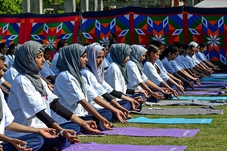School girls perform yoga at a park to mark International Yoga Day in Srinagar, Indian administered Kashmir. Hundreds of Yoga Practitioners participated in Mass Yoga function to mark the International Day of Yoga in Srinagar. The Yoga Day, is celebrated annually on June 21 since its inception in 2015.