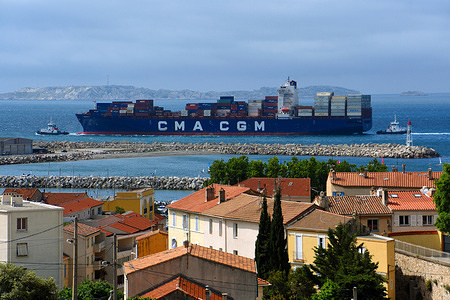 An over view of the container ship CMA CGM "Olivia I" guided by tugboats, on arrival in Marseille.