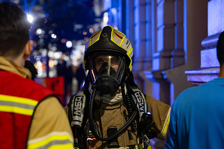 A firefighter speaks to the incident commander while wearing full firefighting gear. A fire broke out in Woolworths on Elizabeth Street. Firefighters and first responders have confirmed the fire is out.